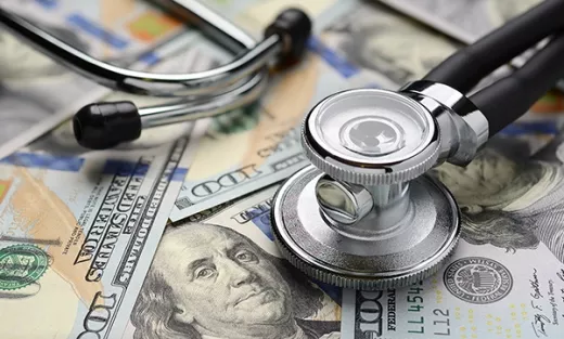 Stethoscope on a pile of money